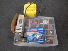 A box containing fishing lures, a drill bit set, Black and Decker electric drill,