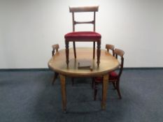 A Victorian extending mahogany dining room table together with six dining room chairs.