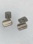 A pair of silver cufflinks