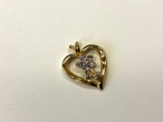 A 10ct gold tanzanite and diamond heart pendant, the five round tanzanite stones approximately 0.