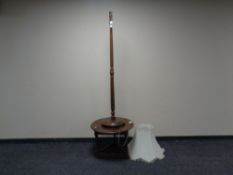 A small oak low table together with a standard lamp.