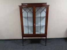 A Victorian inlaid mahogany display cabinet.