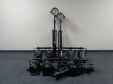 A quantity of stage lighting with bar and stands.