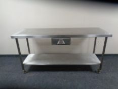 A stainless steel two tier preparation table.