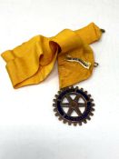 A Rotary International medallion on ribbon
