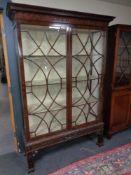 A late Victorian Chippendale style astral glazed mahogany bookcase on stand