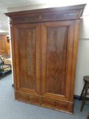 A 19th century continental mahogany two drawer wardrobe