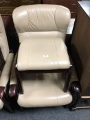 A beech framed cream leather upholstered armchair and matching footstool