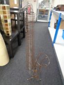 A wire metal CD stand in the form of a saxophone