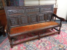 An 18th century carved oak settle