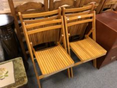 A set of four folding kitchen chairs