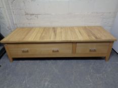 A contemporary pine low storage table fitted with two drawers