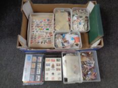 A box containing a large quantity of world stamps loose and in albums with British stamps