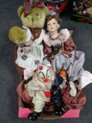 A box containing dolls and clown figures,