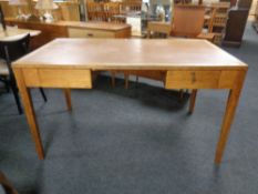 An Edwardian oak writing table fitted with two drawers