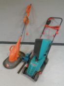 A Bosch Rotak 32 R electric lawn mower together with a further Flymo electric lawn mower and a