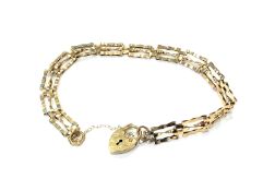 A 9ct gold padlock bracelet CONDITION REPORT: 3.
