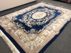 A fringed Chinese carpet on blue ground, 273 x 367 cm.