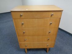 A mid-20th century four drawer chest.