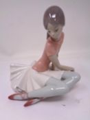 A Lladro figure - Seated dancer.