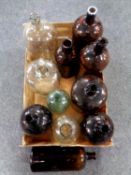 A box containing a quantity of clear and brown glass brewery bottles and demijohns.