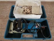 A Makita biscuit joiner, cased, together with a box of woodworking biscuits.