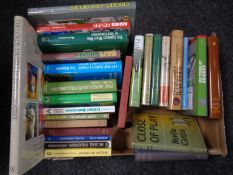 A box of books relating to cricket.