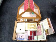 A pine framed dolls house containing a quantity of assorted dolls house furniture and lighting kit.