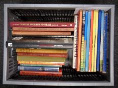 A box of books relating to football.