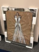 A picture depicting a dress in a mirrored frame, 73 x 92 cm.
