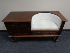 A carved oak linen fold telephone seat.