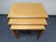 A nest of three 20th century teak tables.