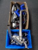 A crate and a box containing a large quantity of car exhaust parts.