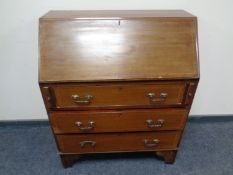 A 19th century mahogany writing bureau with marquetry inlay.