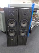 A pair of Acoustic Solution floor-standing speakers.