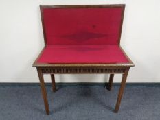 An Edwardian mahogany turn over top card table.