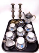 A tray of antique brass candlesticks together with a Japanese tea service