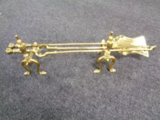 A brass fire companion set on stands