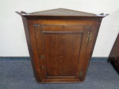 A 19th century oak panel door hanging corner cabinet.