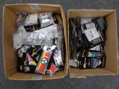 Two boxes containing a quantity of souvenir sew-on patches, keyrings and enamel badges.