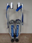 A pair of adjustable drywall stilts.