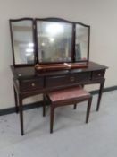 A Stag Minstrel three drawer dressing table with triple mirror and stool.