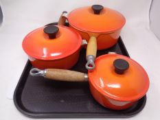 Three graduated Le Creuset cast iron sauce pans with lids (as new)