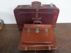 Four vintage leather briefcases/satchels together with a vintage luggage case.