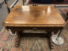 An early Victorian carved oak library table fitted a drawer,