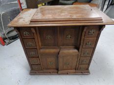 A Singer treadle sewing machine in a cabinet.