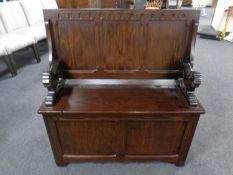 A reproduction oak monk's bench.