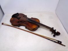 A late 19th century German violin and bow with carved lions head scroll, two-piece 14