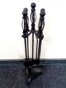 A four-piece companion set on stand.