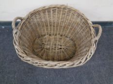 A wicker twin handled log basket.